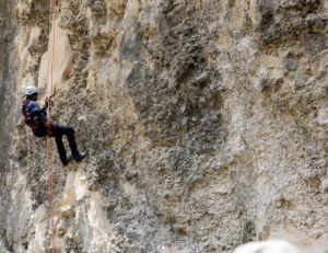 Participant repelling down a cliffside during disaster preparedness training in Barbados, documented by Maven Photo + Film for My Medic.